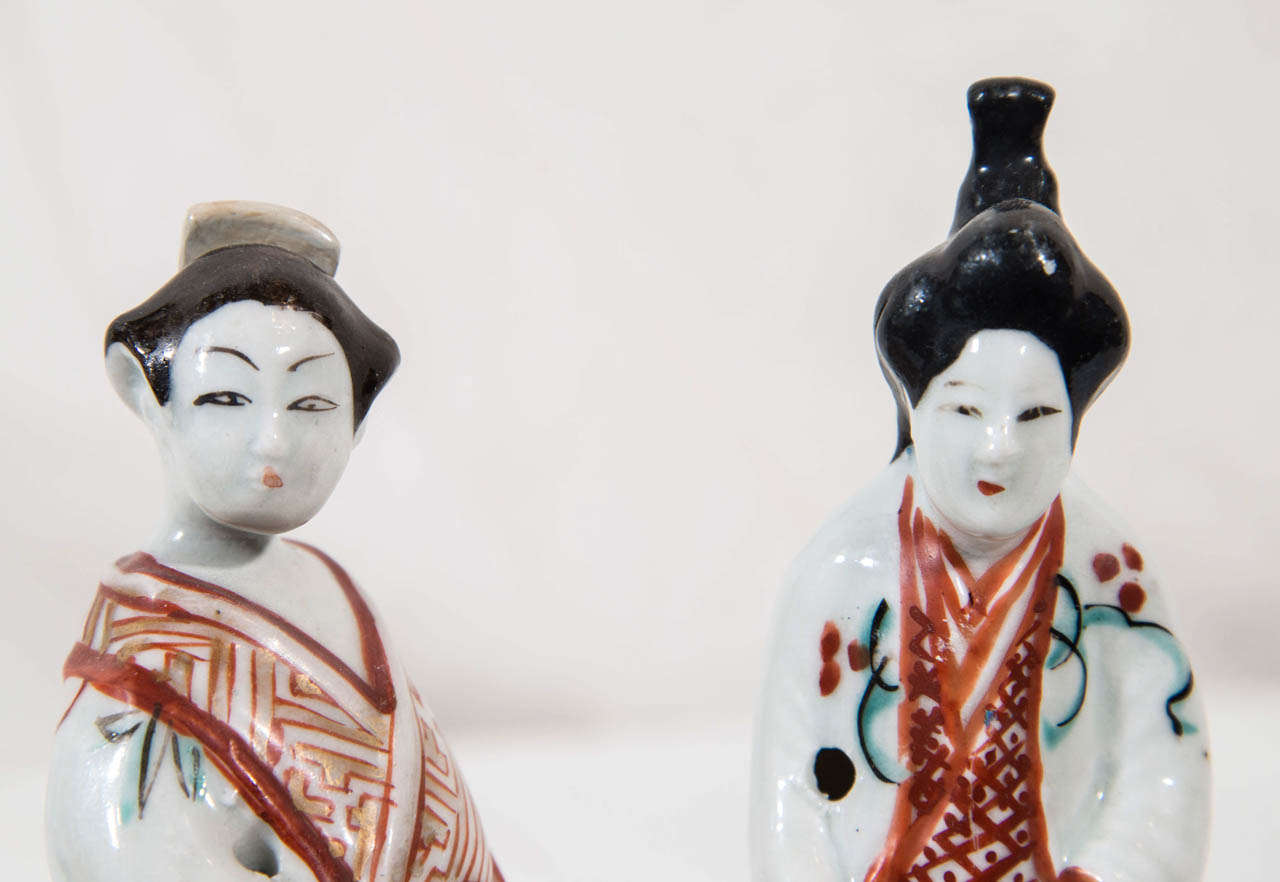 Japanese in style, this pair of figures were made for export to Europe.
Made in and around Arita in northern Kyūshū in the late 18th or early 19th century during the Edo period they are decorated in dark underglaze blue and overglaze colored