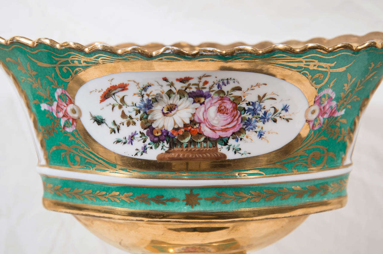 An elegant Paris Porcelain basket (corbeille) in the Sevres style. Oval in shape and raised from a rectangular base, the sides painted in French green and gilt with large reserves filled with beautifully painted flowers.