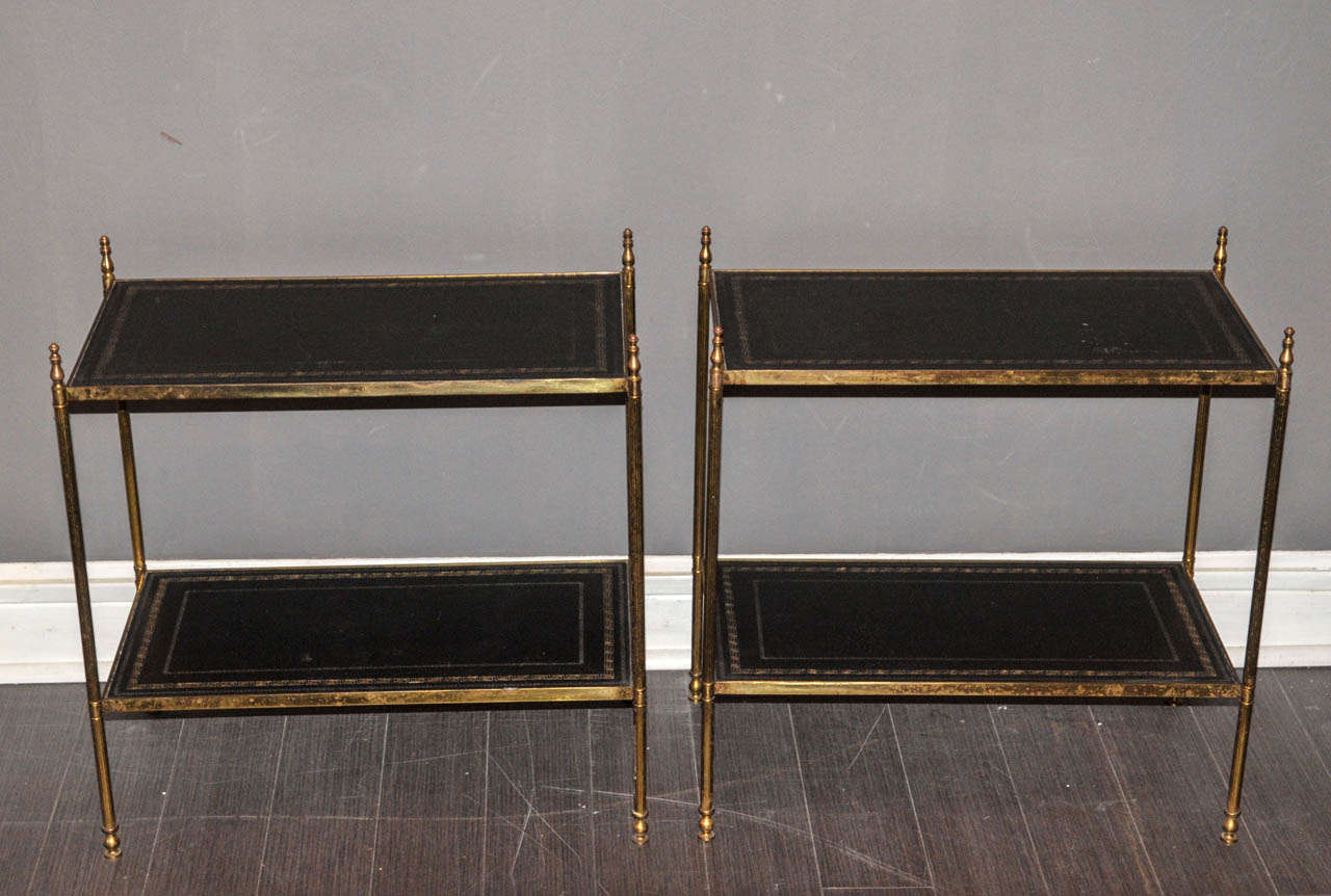 Pair of 1950's brass end sofa tables. Black leather covered top. Good condition. Normal wear consistent with age and use.