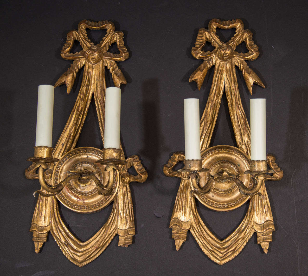 Pair of L.XVI Style Giltwood And Gesso Two Light Sconces With Ribbon, Bow And Tassel Motif.