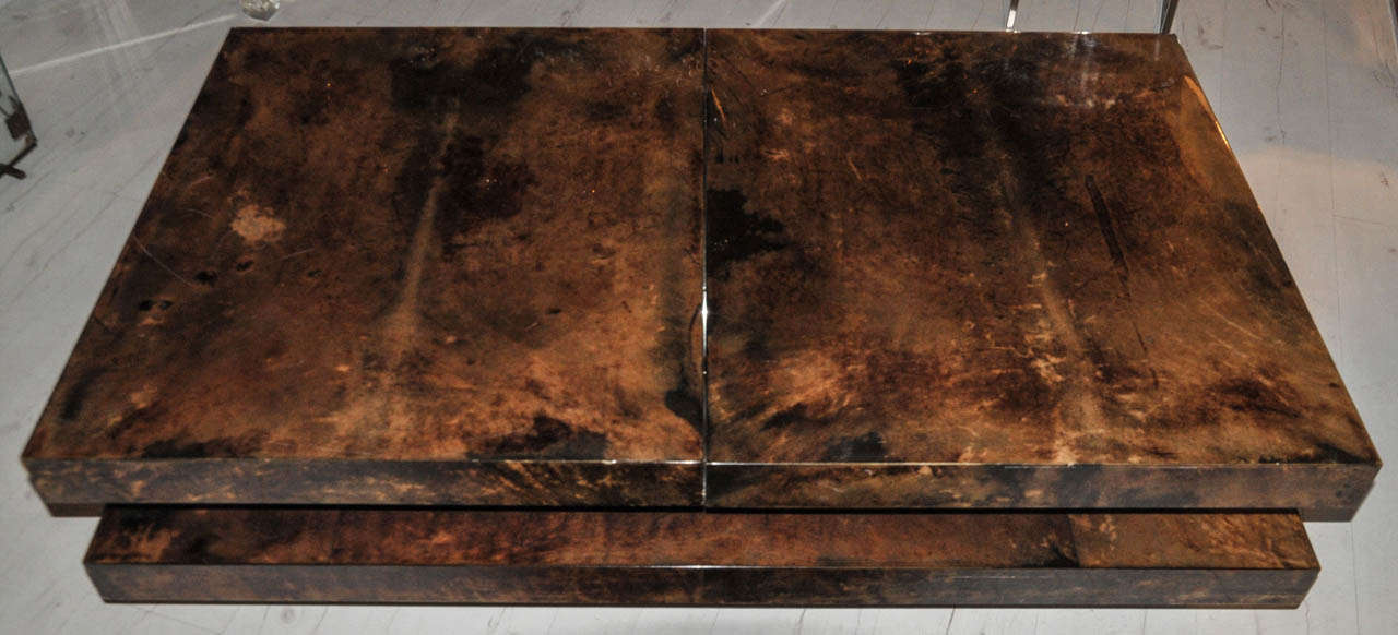 1970's dry bar coffee table attributed to Aldo Tura. Covered with brown lacquered tainted parchment. Some scratches on the tops. Good condition. Normal wear consistent with age and use. 

Dimension closed: Height 39cm x Width 140cm x Depth