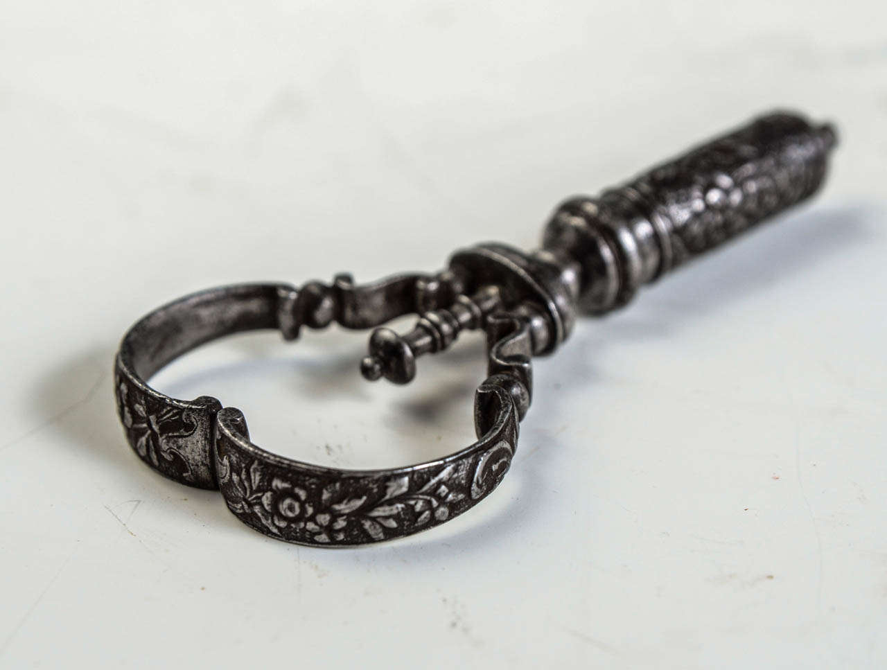 Wrought Iron Corkscrew decorated and chiseled with flowers.