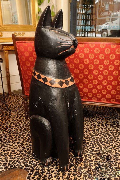 The cat is carved out of solid Teak.
Painted in black and beige.
Quite heavy.