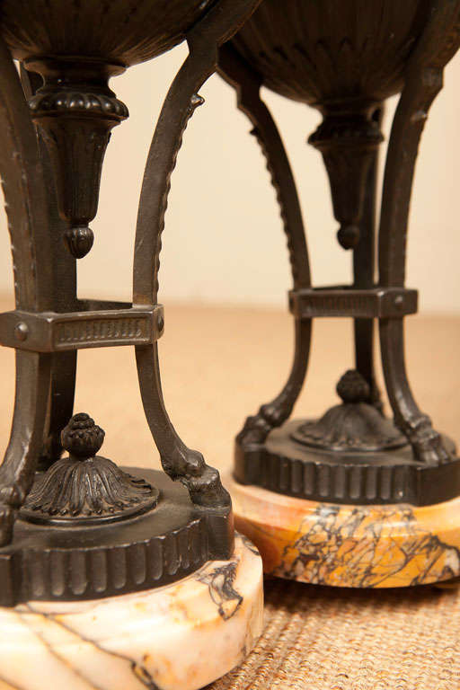 Patinated Bronze Tripod Cassolettes with Ram head mounts on a beige marble base

View our complete collection @ www.hollisandknight.com