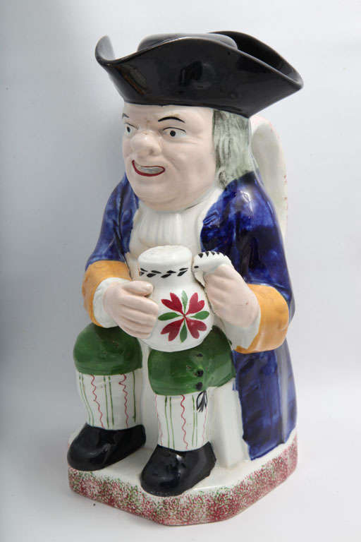 A rare signed Davenport pottery toby jug and cover decorated in underglaze Pratt colors, impressed Davenport and Anchor
