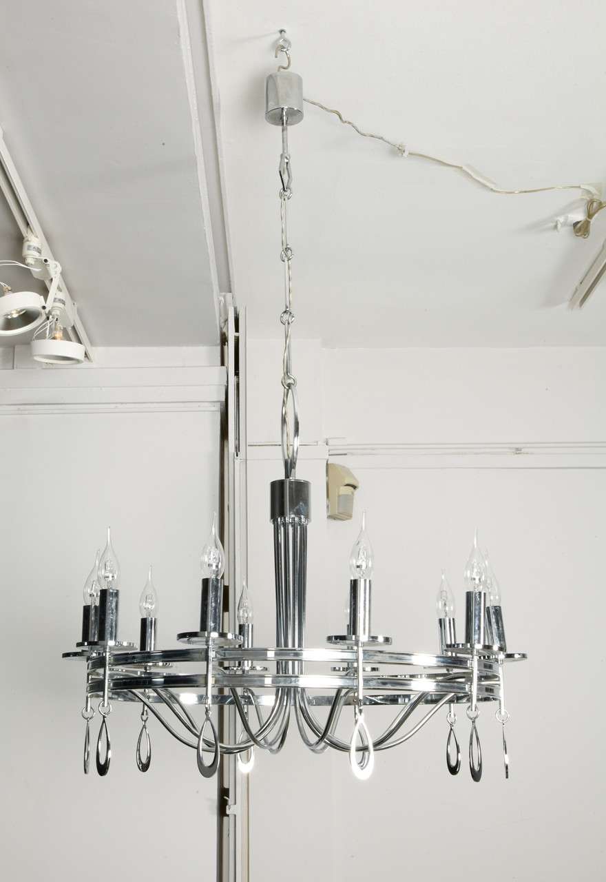 A highly decorative 10 lights nickeled metal chandelier, with 10 tear-shaped pendants, Italy, 1960's
Height including the chain : 125 cm / 49,21 inches
Height : 70 cm / 27,55 inches
Diameter : 75 cm / 29,52 inches