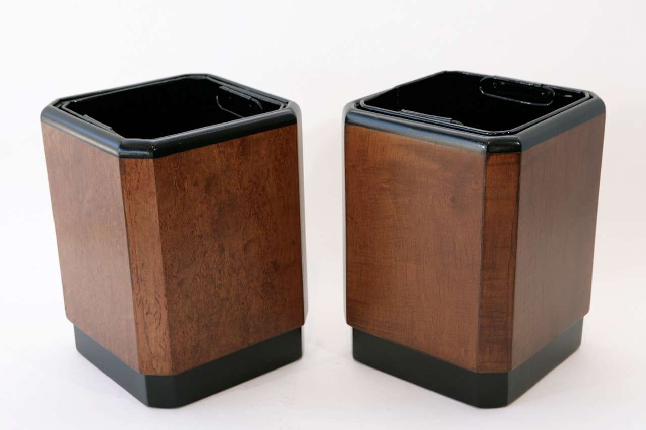 A handsome pair of mahogany wastebaskets with black painted banding from the RMS Queen Mary. They have removable handled black enameled metal liners. The bottoms of each wastebasket  stamped with their deck and stateroom number.