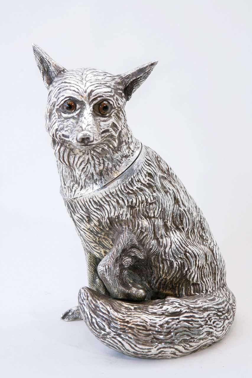 A strikingly realistic hand chased silver plate fox champagne or wine cooler with glass eyes. The head flips open to stash a bottle of champagne (see Image 3) and the interior has a plastic liner. Stamped 