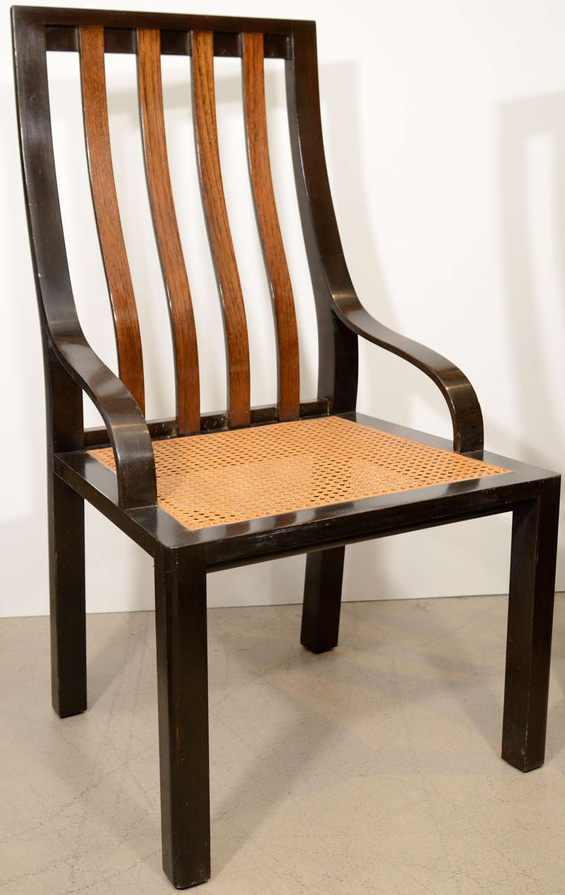 An unusual pair of high-backed side chairs in ebonized walnut with rosewood backsplats and caned seats. Strking combination of rectalinear and curving elements. 