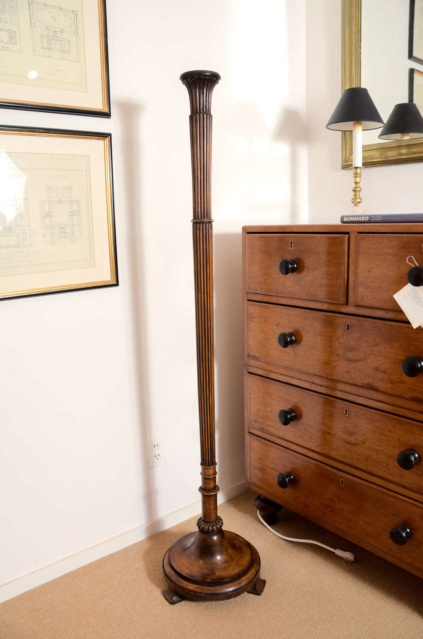 A turn of the century mahogany floor lamp. The base measures 13" in diameter.