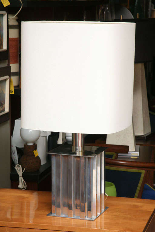 REDUCED FROM $885.
With a polished aluminum geometric form, this table lamp from Brazil has strong machine age influences and a very modern profile and great presence. Unique built in shade attachment design and an on/off switch on the top plateau.