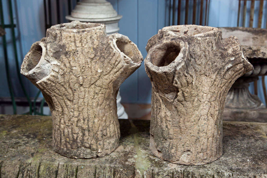 This is a great and quite unusual pair of faux bois tree trunk planters in generally very good condition with little bits of exposed iron armature.  These would be magnificent potted up with feathery papyrus or undulating grasses.