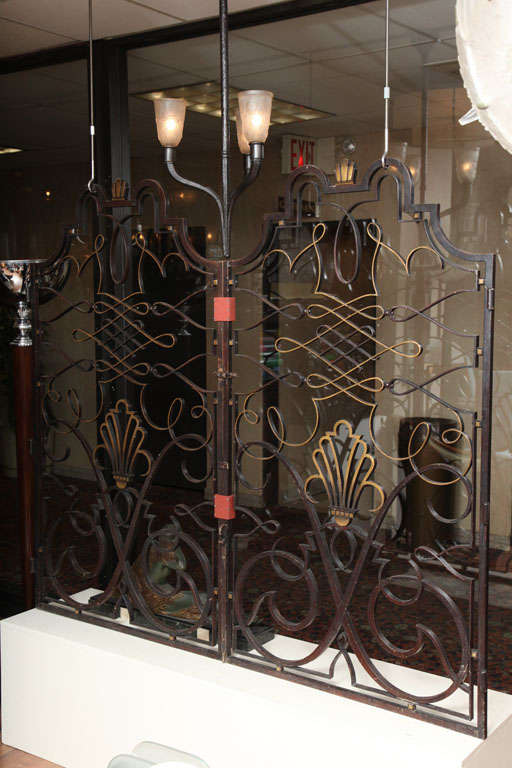 Patinated and gilded wrought iron apartment gate from circa 1940, attributed to Raymond Subes.