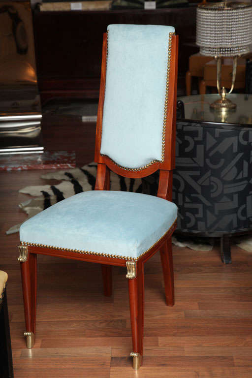 Set of six 1940s dining room chairs in solid mahogany, with gilded bronze accents, upholstered in light blue velour.
