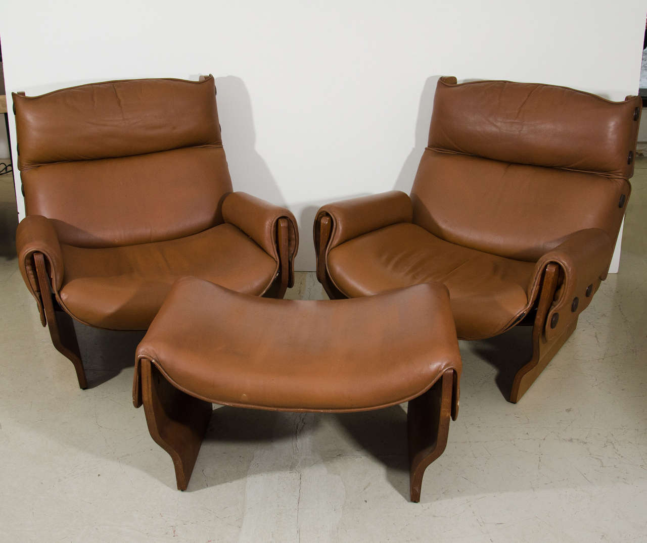 Iconic Canada lounge chair and ottoman suite in a luggage color leather seat and armrests with rosewood frame. So comfortable.