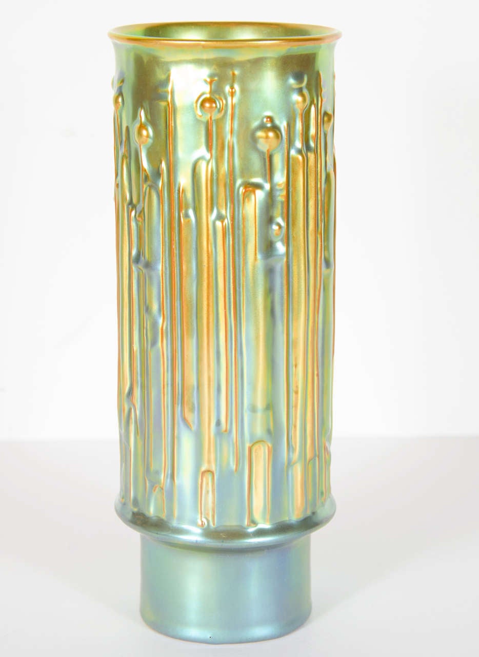 This vase features inspired design interpreted in an Art Deco manner. A beautiful hand painted iridescent glaze on this piece, this vase is made by the noted and renowned Zsolnay porcelain company in Hungary. It is signed on the bottom 
