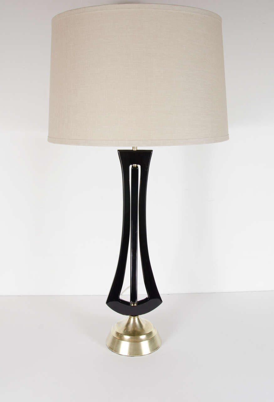 This pair of magnificent Mid-Century Modernist table lamps have an interlocking geometric form in ebonized walnut and brass fittings. They are in excellent condition and would aesthetically be perfect for any room. They have been completely rewired