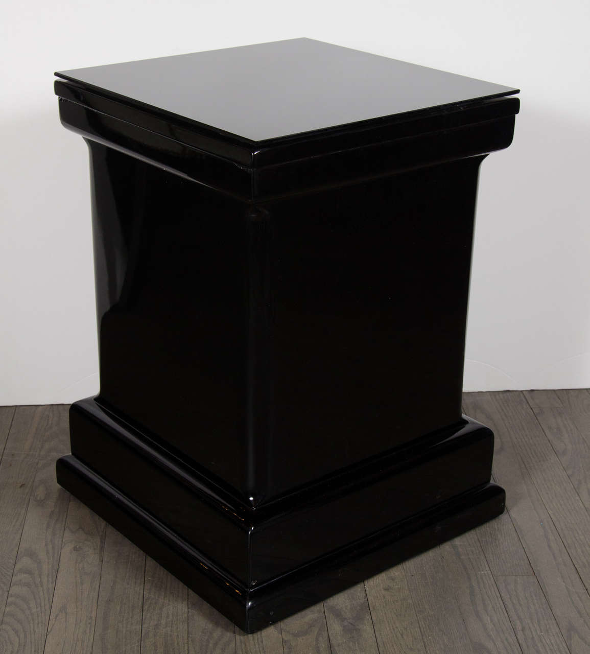 This exceptional pair of Art Deco Style end tables features a skyscraper pedestal form with black vitrolite tops. These would make any grandiose accent ostentatious adding wonderful style to any room. They can also be used as pedestals side tables