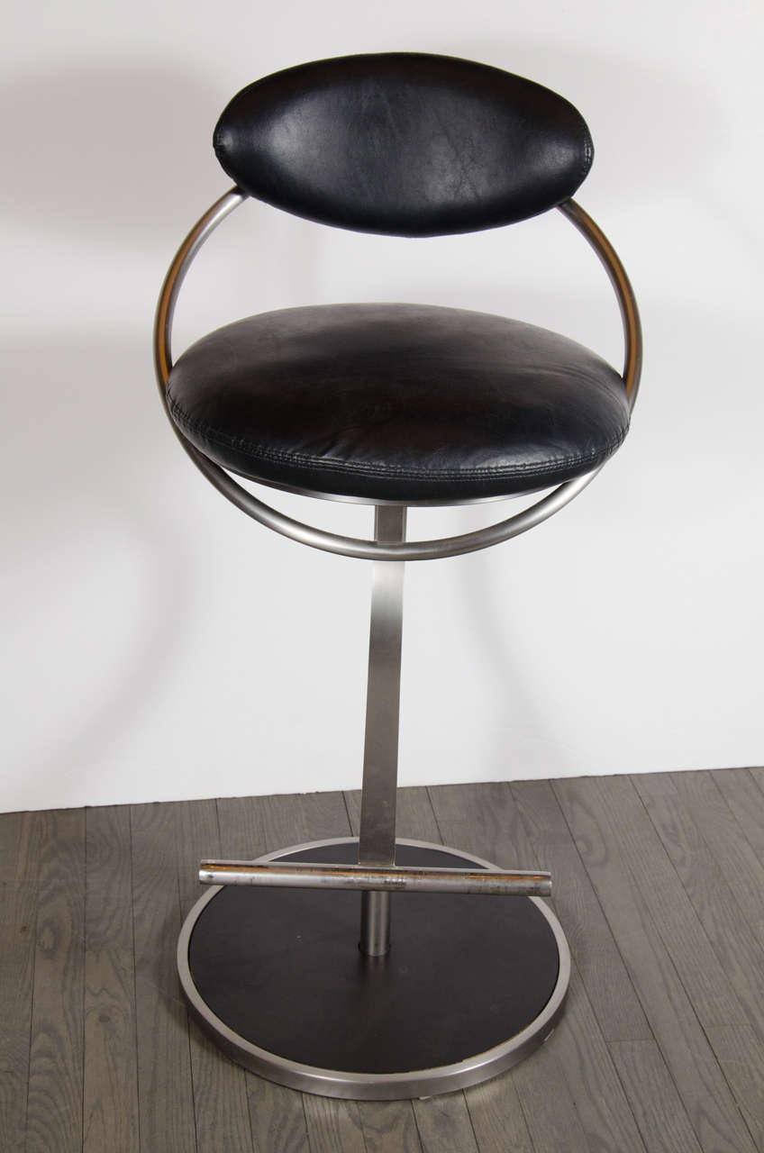 These very sophisticated set of four modernist floating elliptical cantilever bar stools with black leather upholstery feature a futuristic look with is continuous curved shapes. Each barstool has a black leather pillow cushion seat with an ovoid