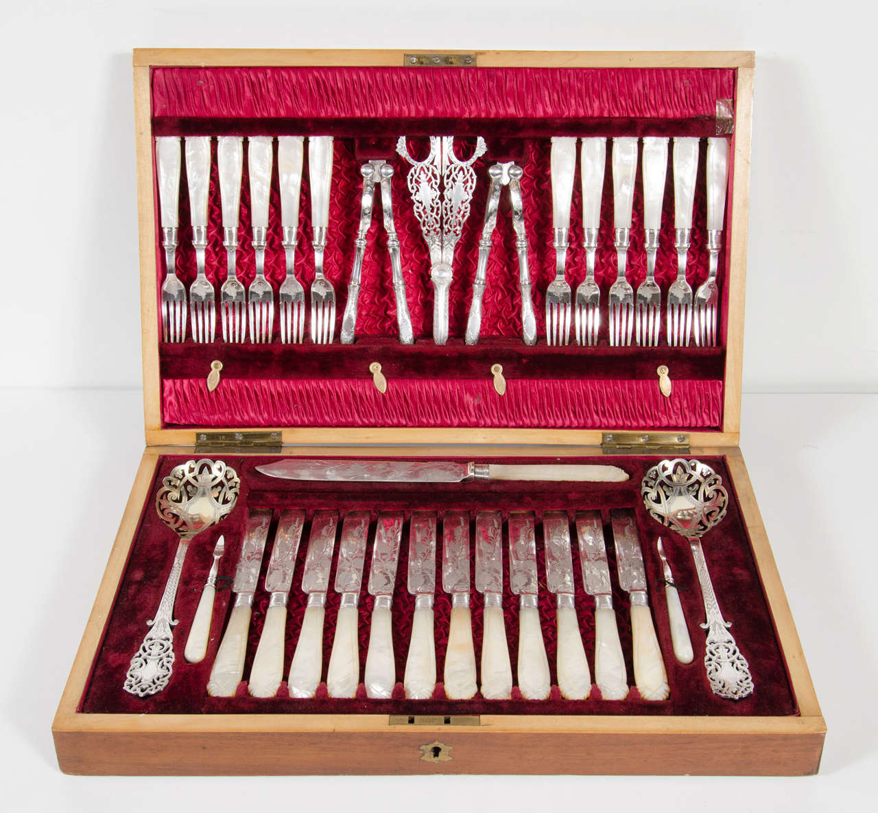 Elaborate silver and mother-of-pearl, silver plate flatware set. Original box with shield crest and fittings and was originally commissioned by The Earl of Tankerville of Chillington. It is comprised of 12 forks, 12 knives, two nut crackers, two nut