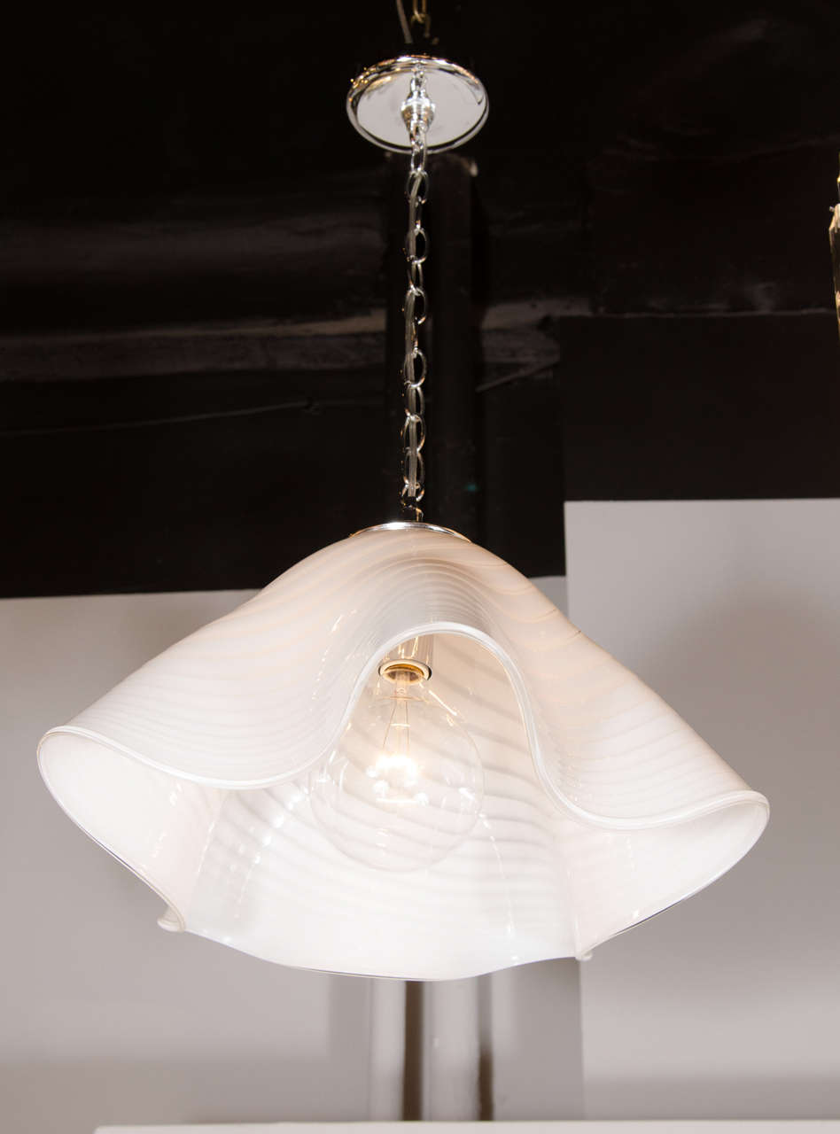 This magnificent Mid-Century Modernist Murano chandelier features a hand blown Murano glass  handkerchief form with chromed fittings. This chandelier would add amplitude to any room or area. It has been rewired to American standards and is in