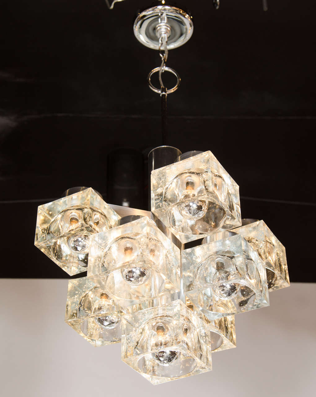 This astonishing Mid-Century Modern chandelier by Sciolari features square ice cube silhouette with chrome detailing. It has been newly rewired and the height can be adjusted to suit and even hung as a flush mount chandelier.