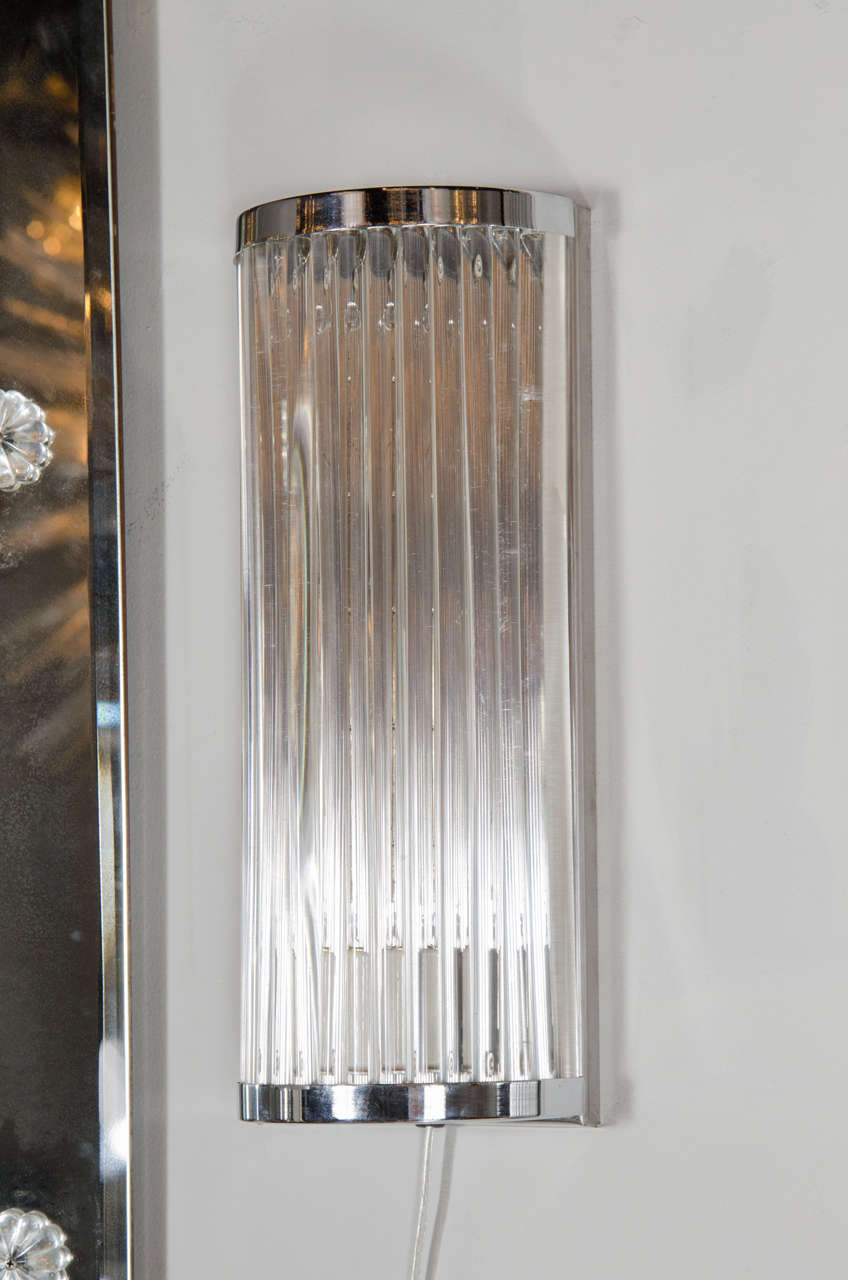 This exceptional pair of Art Deco Machine Age sconces feature a demi-lune design with clear lucite rods secured in place with a chrome frame. When lit from behind the parallel rods diffuse the light and creates an dramatic effect. Each sconce takes