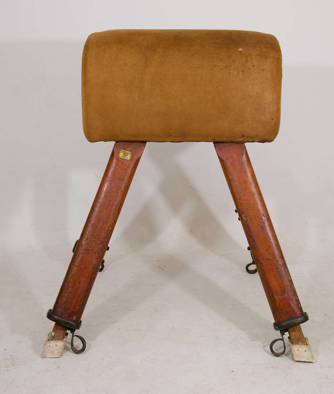 Remarkable pommel horse by H. Hunt & Sons of Liverpool in suede and oak. The legs are adjustable. This piece has great character as a visual element as it is; some designers might choose to use the nicely worn suede part as a bench top and the legs