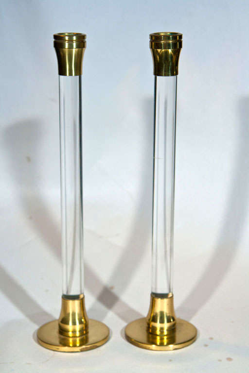 Pair of Modernist Lucite and Brass Candlesticks.  For your review are two epitome tabletop vintage candlestick pairs. These modernist accoutrements boast lavish lucite and brass accents. Their heights maximize their visual effect.  As with most