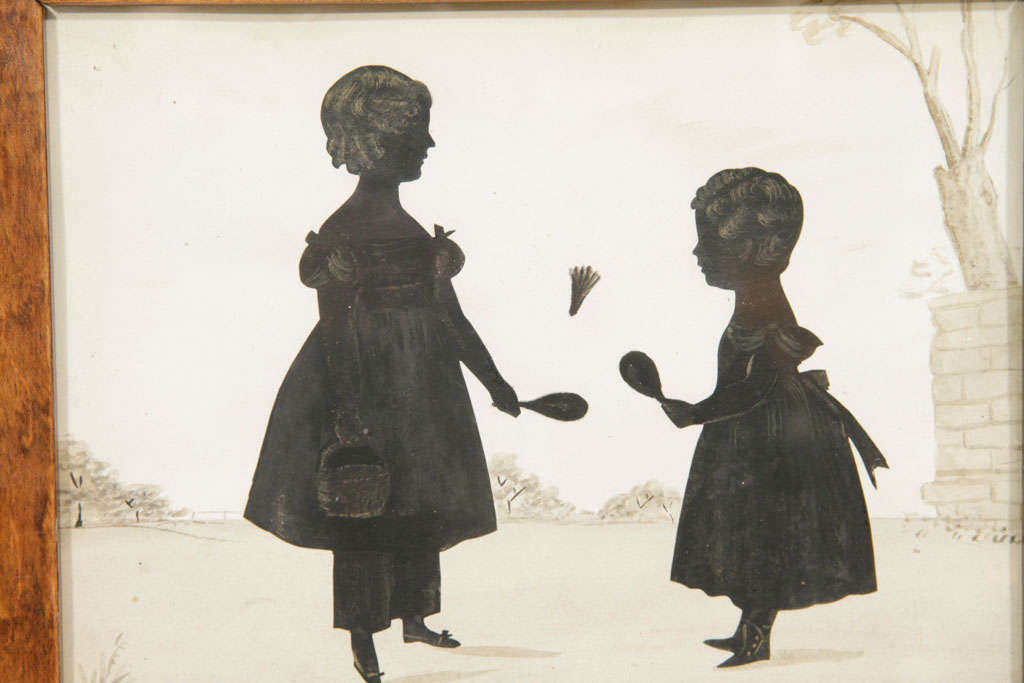 An English Cut Silhouette of 2 Girls Playing Badminton
