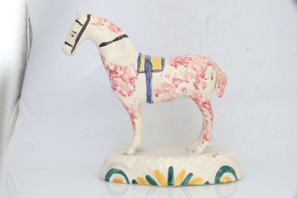 A fine English pearlware pottery pony on a raised base, painted in underglaze Pratt colors