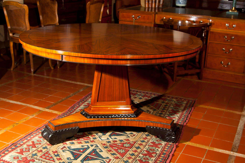 This rosewood lune table is handmade for us by our English cabinetmaker and features radial cut veneers on the self-banded top to striking effect. True to its Regency style, it features an apron and ebony stringing. The modified trefoil pedestal