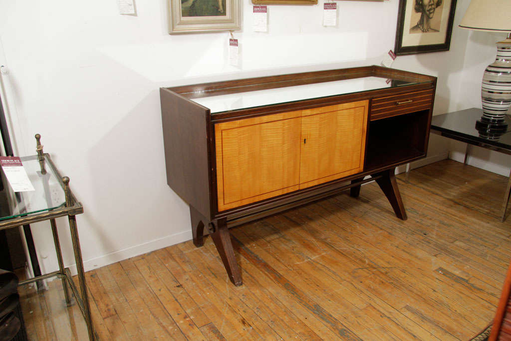 A German sideboard or liquor cabinet with remnants of the paper label on the back. The top surface is mirrored, as is the back of the doored cabinet interior. A single pull drawer and open cabinet provide extra storage.<br />
<br />
Reduced From: