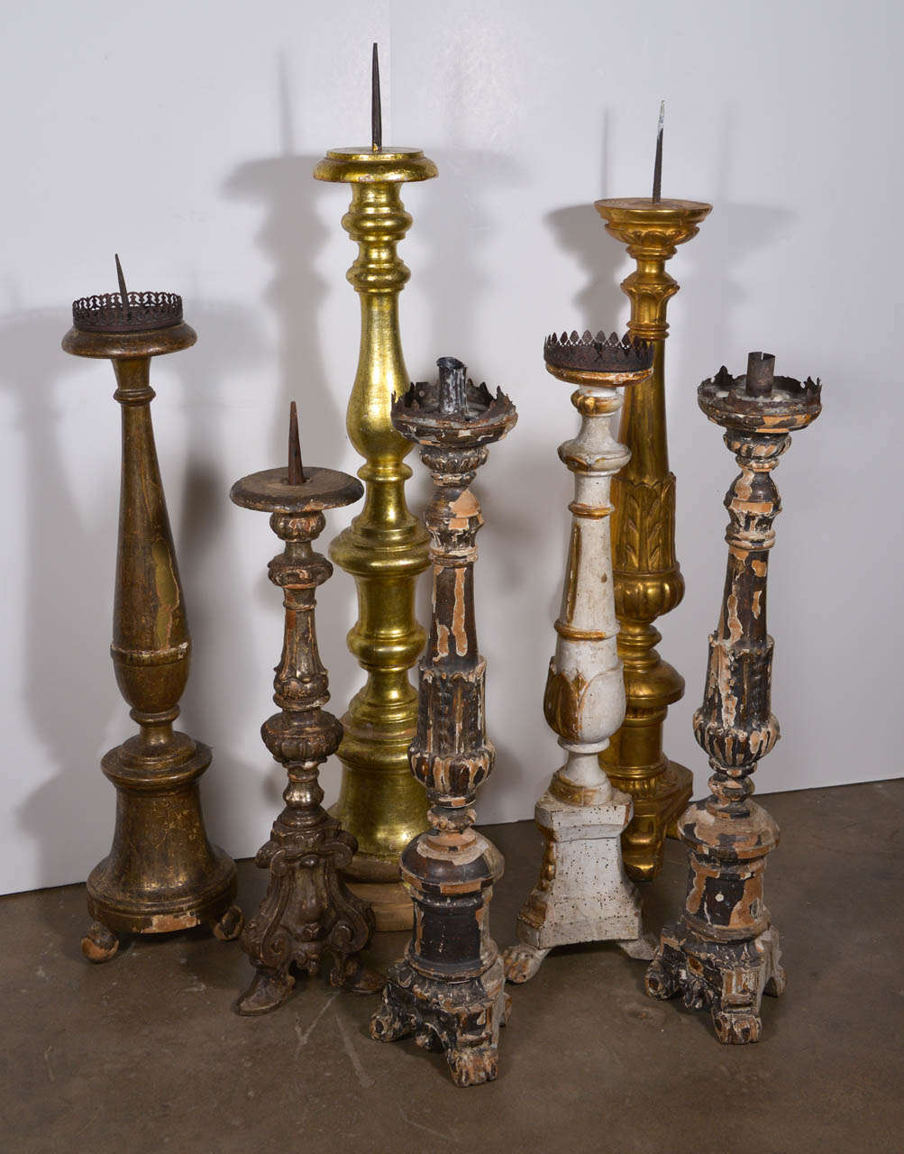 Sold Individually but shown as a group are a variety of gilt, painted and silver leaf candlesticks.  They range in size and price. the smallest is 27