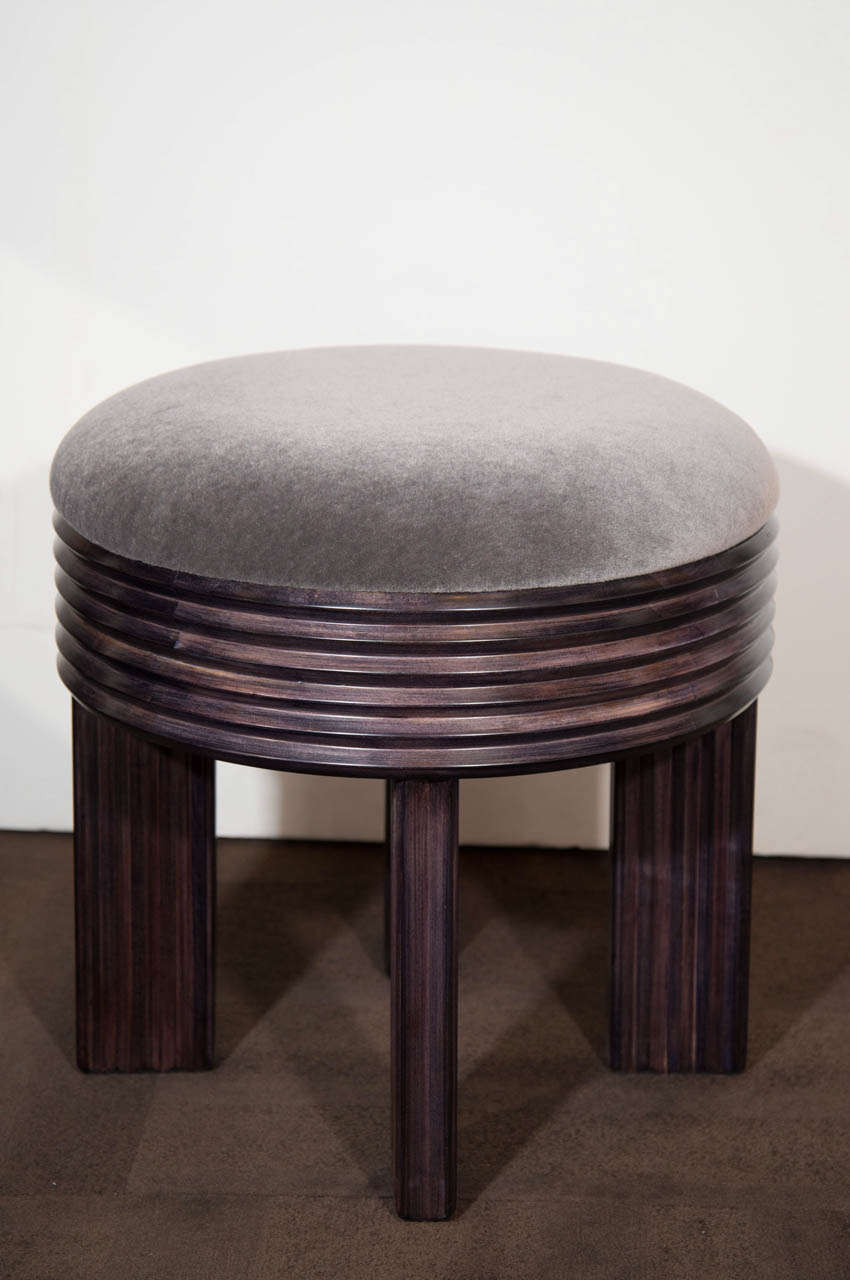 Outstanding Art Deco stool or ottoman with Machine Age design. The stool has a gorgeous fluted base and leg design in a dark satin walnut wood, and has been upholstered in a luxe charcoal grey mohair.