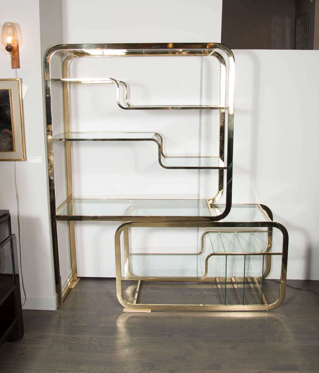 Impressive Mid-Century Modern brass  and glass etagere with great modular design by Milo Baughman. This etagere features a innovative cantilever base that can moved from left to right to either widen the design or make it more streamline which