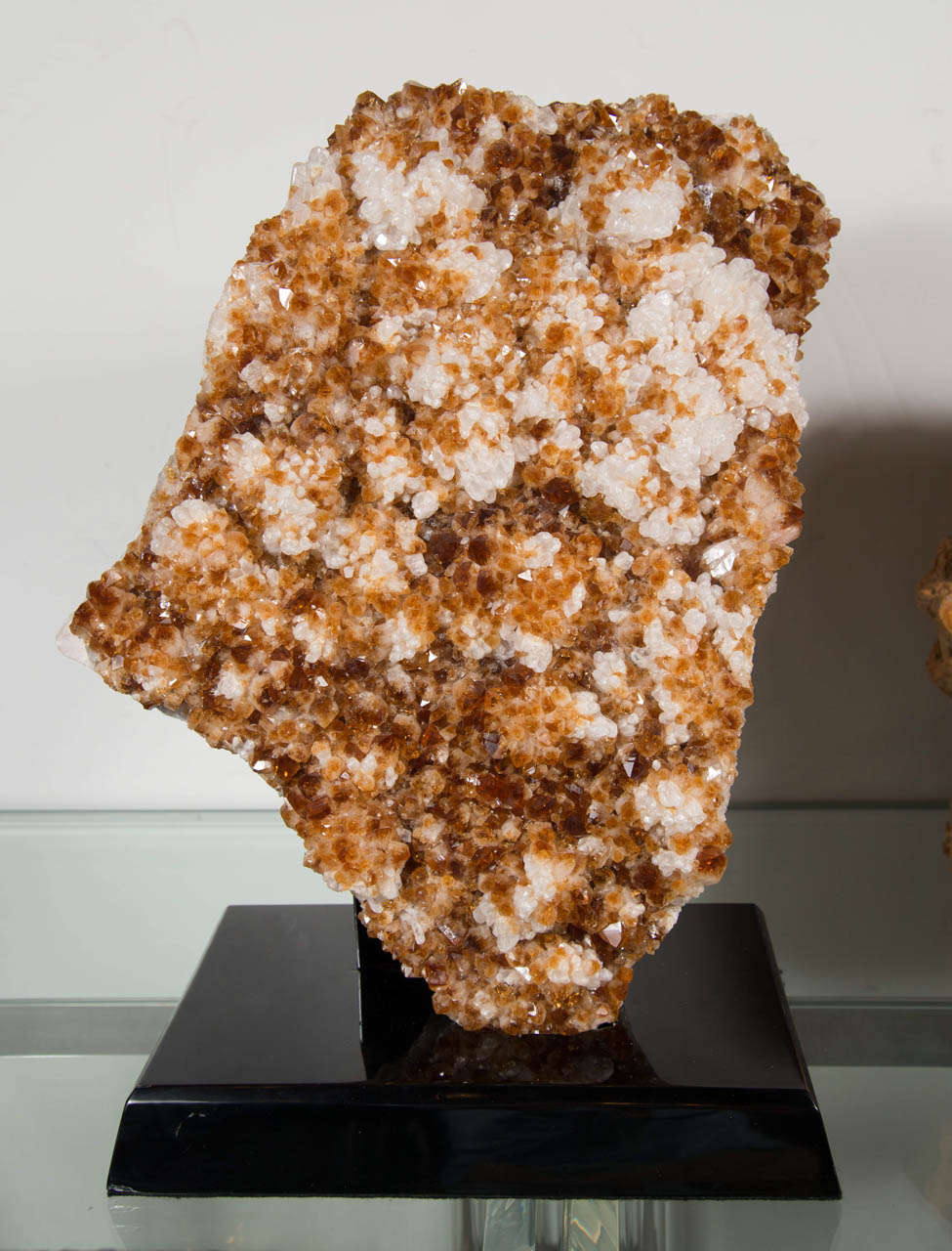 This large sliced citrine crystal specimen with brilliant colors has a beautiful organic shape and features amber and gold tones and will work as a centerpiece in any design. It is mounted on an ebonized walnut pedestal.