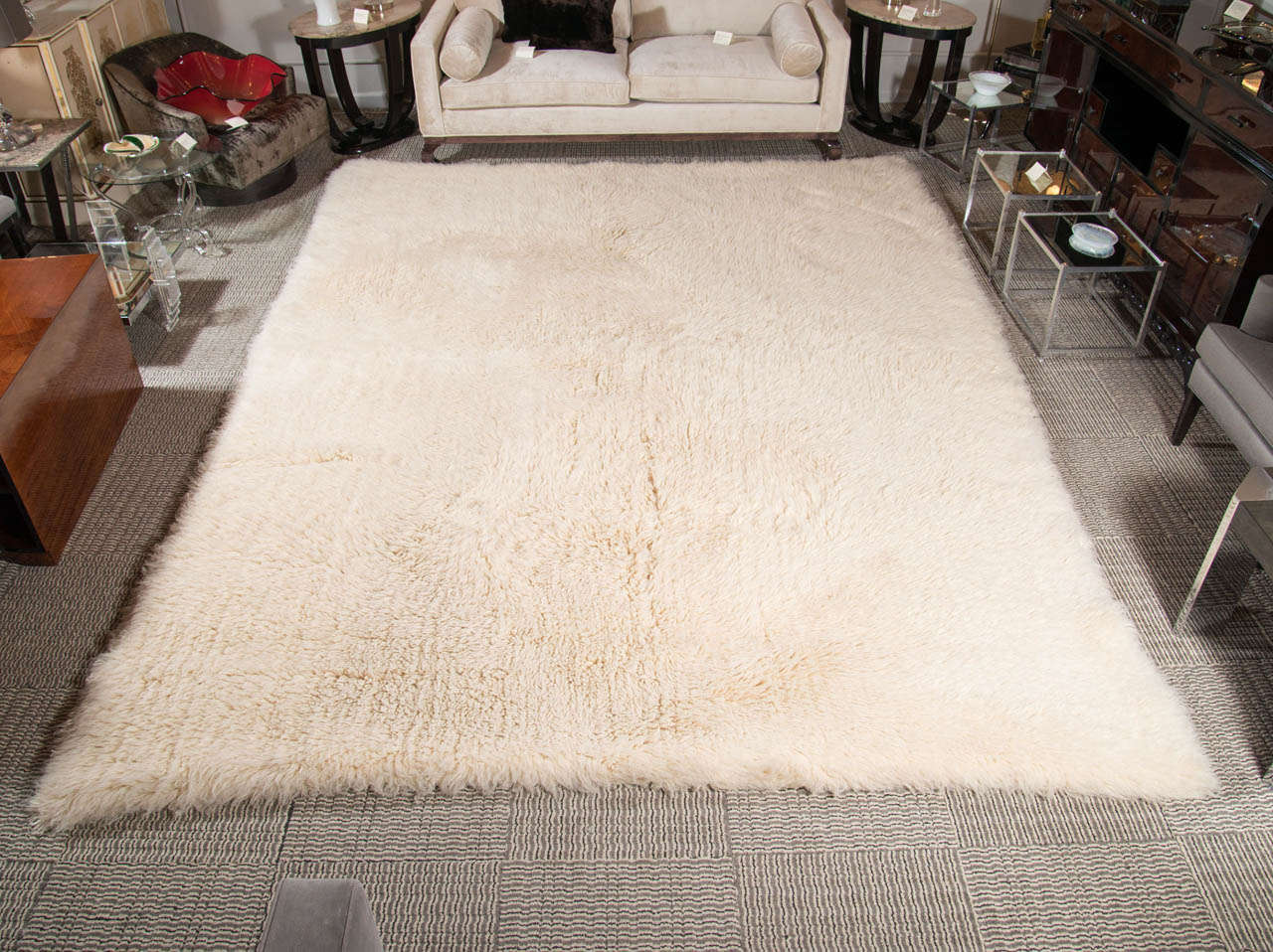A luxurious 9 x 12 genuine Mazarakis Flokati rug.  It is made of 100% New Zealand wool pile and is hand woven in Greece with a wool backing.  It has a high pile which gives a thick and luscious feel and look.