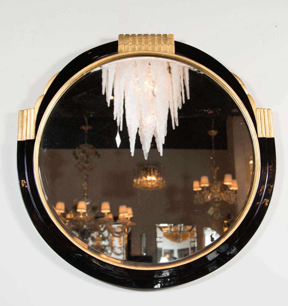 This gorgeous mirror is made of ebonized walnut with 24 gilt fluted detailing and accents.The mirror also features a hand beveled border detailing surround.