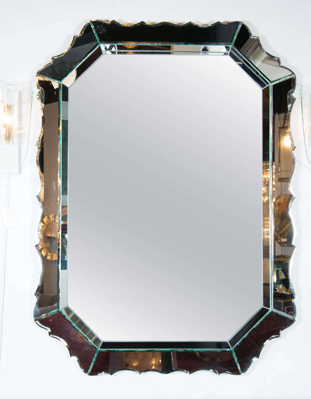 This outstanding 1940's Hollywood shield back mirror features an inset shadow box style octagonal mirror with hand bevelled details.