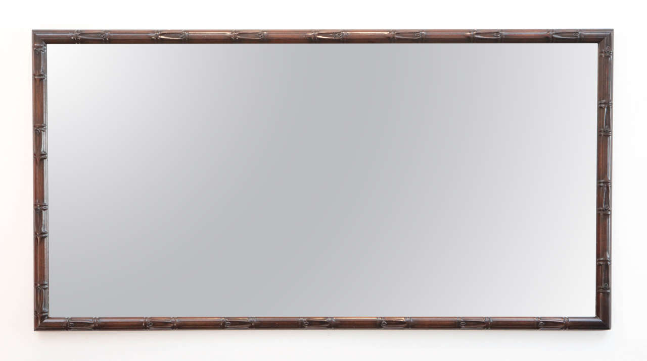 Linear bamboo framed wall mirror.