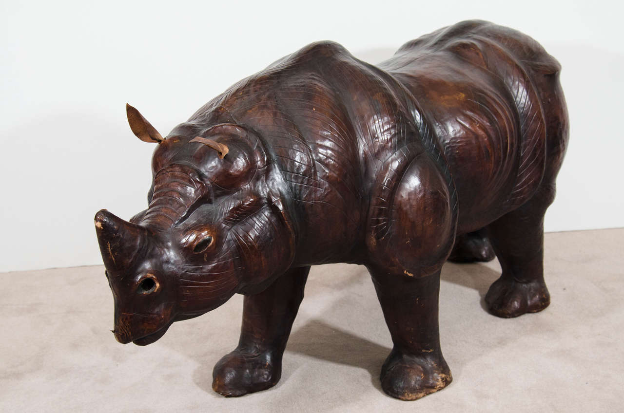 A vintage large brown leather rhinoceros bench or sculpture. Good vintage condition with some spots of wear, particularly around the feet. Some scratches and a few nicks.