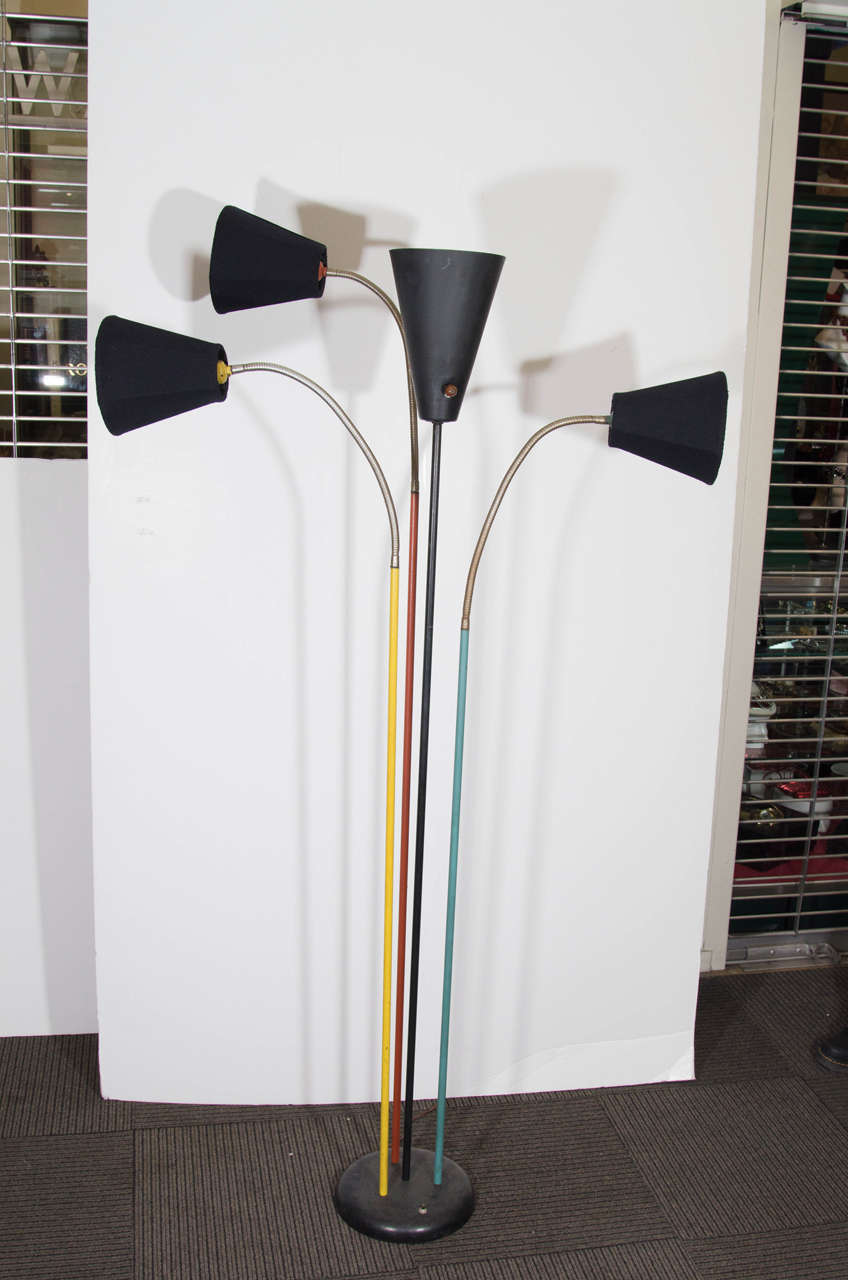 A vintage Greta Grossman adjustable floor lamp with three enameled black conical shades, center torchiere and multicolor poles attached to a black base. Good vintage condition with age appropriate wear. Some nicks to poles.