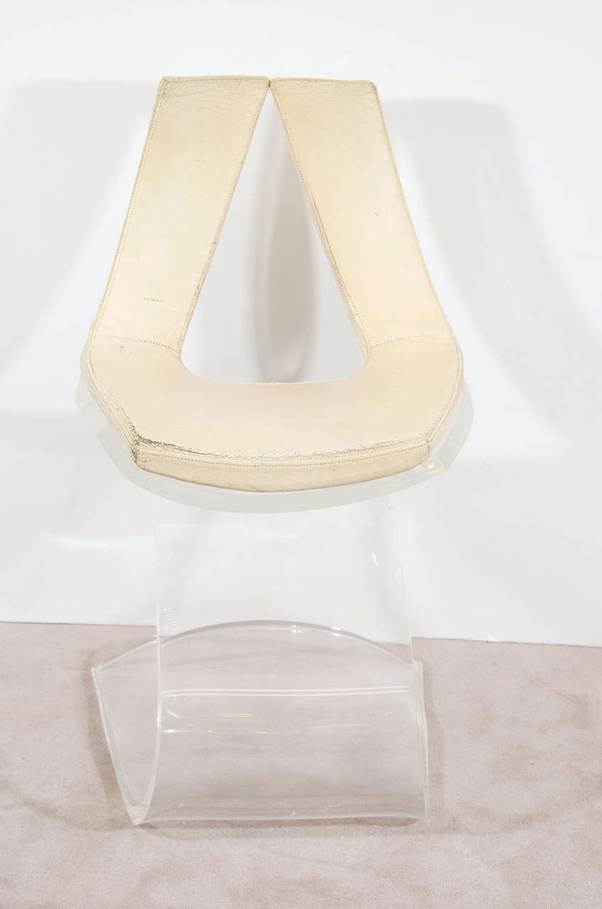 A 1970s French Modern Lucite and leather chair crafted with a single 1