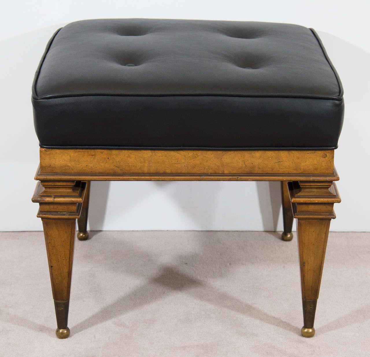 A vintage pair of black leather and burled wood benches with brass ball feet by Weiman Furniture Company.  Newly reupholstered.  Good vintage condition with age appropriate wear.