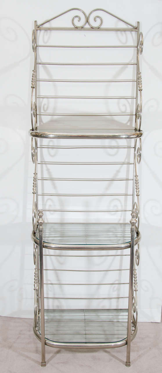 A vintage tall steel and nickel Baker's rack with three glass shelves.  
Reduced from: $1,850