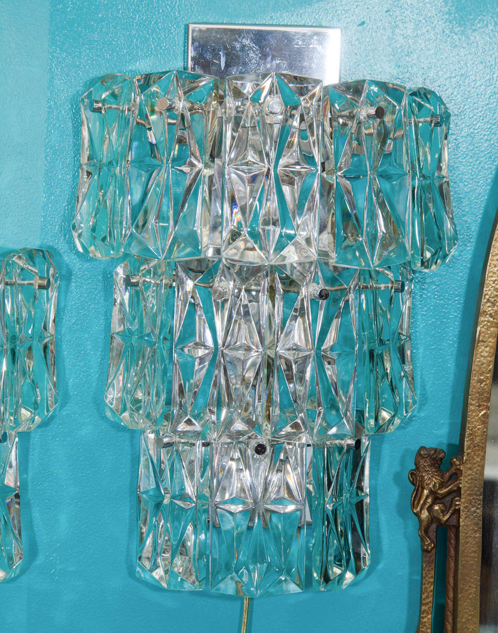 A vintage pair of large Kinkeldey three-tier sconces with clear faceted crystals and chrome mounts. These sconces take six candelabra bulbs.