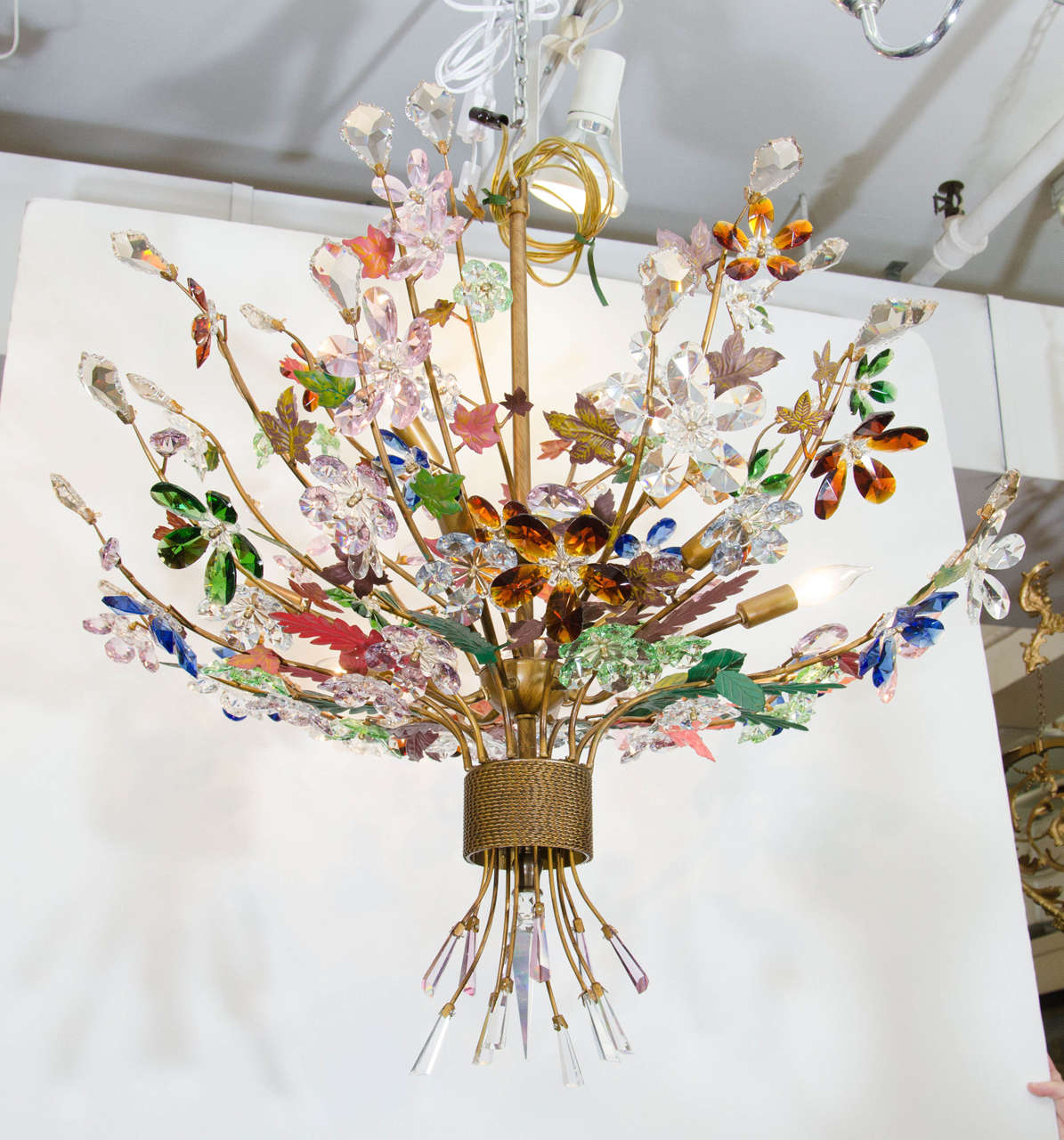 A vintage Italian Murano glass chandelier in the form of a bouquet of flowers with tole leaves. The frame is an antique gold washed metal.  Newly rewired. This chandelier takes 10 candelabra bulbs.