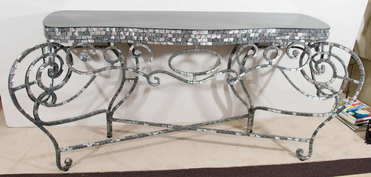 A contemporary French inlaid mother-of-pearl console table with scroll frame.