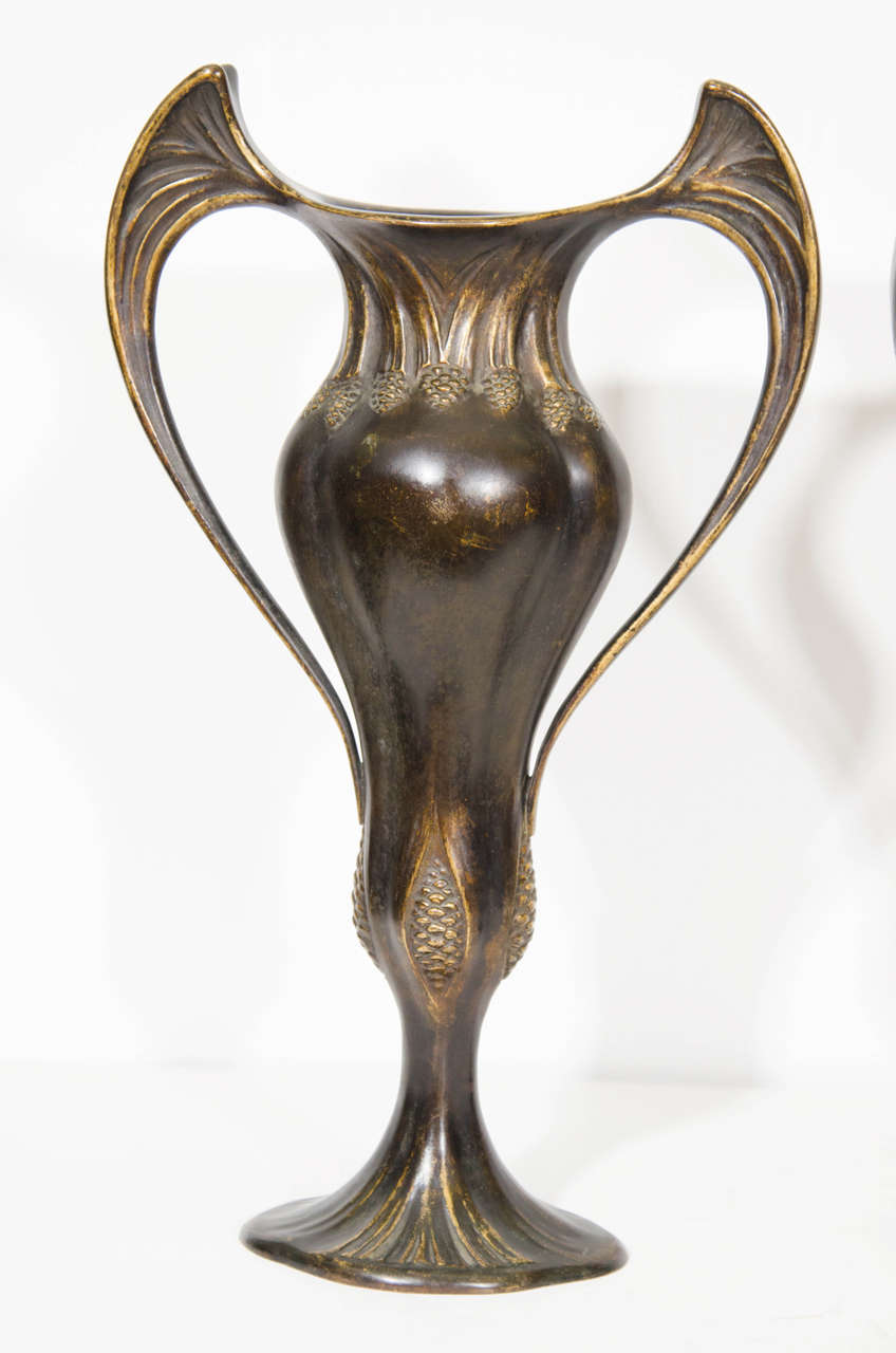 An Art Nouveau pair of French bronze double handled vases by Auguste Delaherche, circa 1900. Signed on the base. Good condition with age appropriate wear and patina.